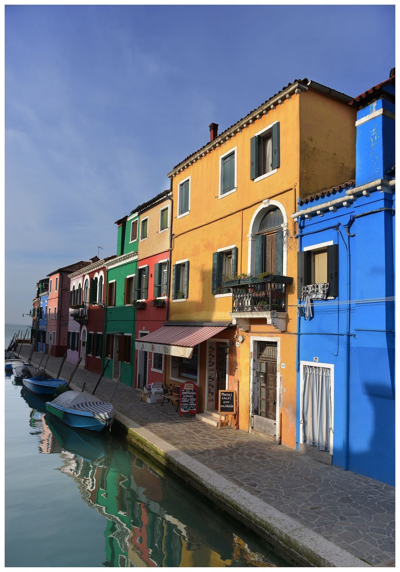 Colorful houses lining a canal in Burano, Venice