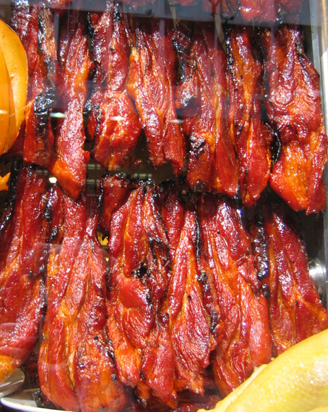 Char siu roast pork hanging in a shop window