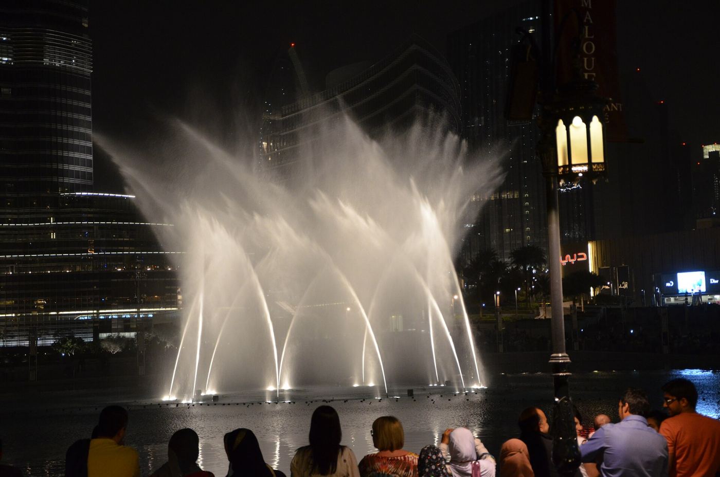 The Dubai Fountain performing at night in front of the Burj Khalifa