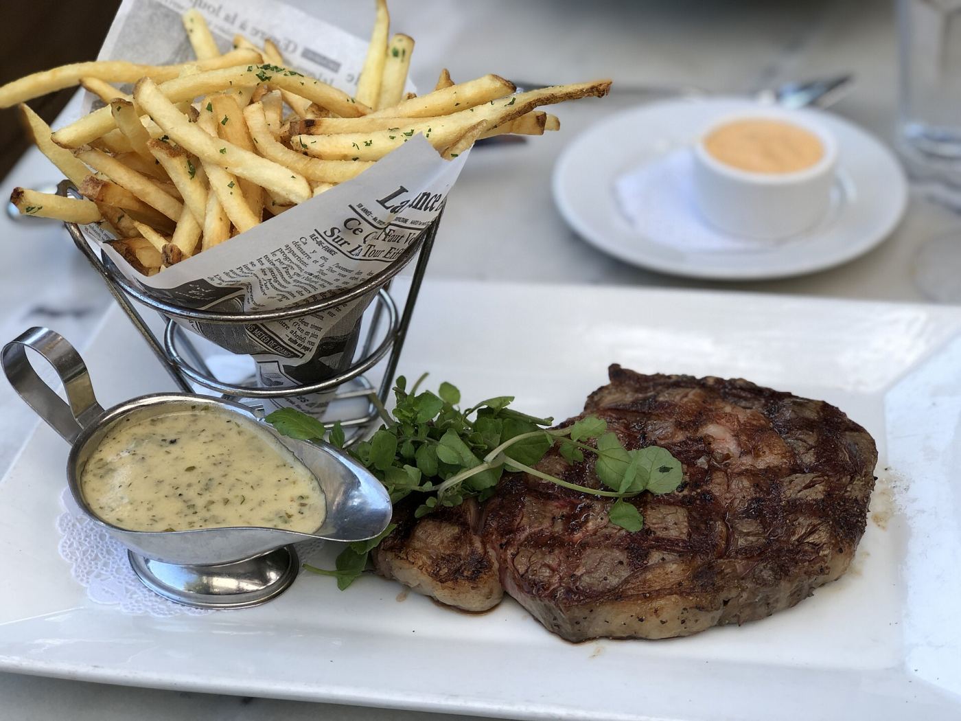 A steak-frites plate served at a Paris bistro