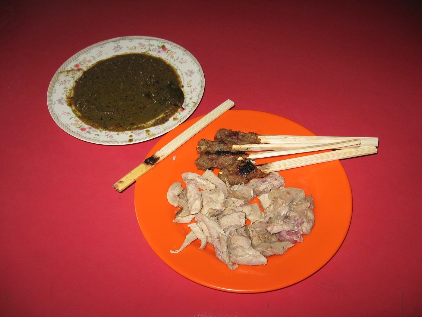 A plate of babi guling with sate lilit and rice