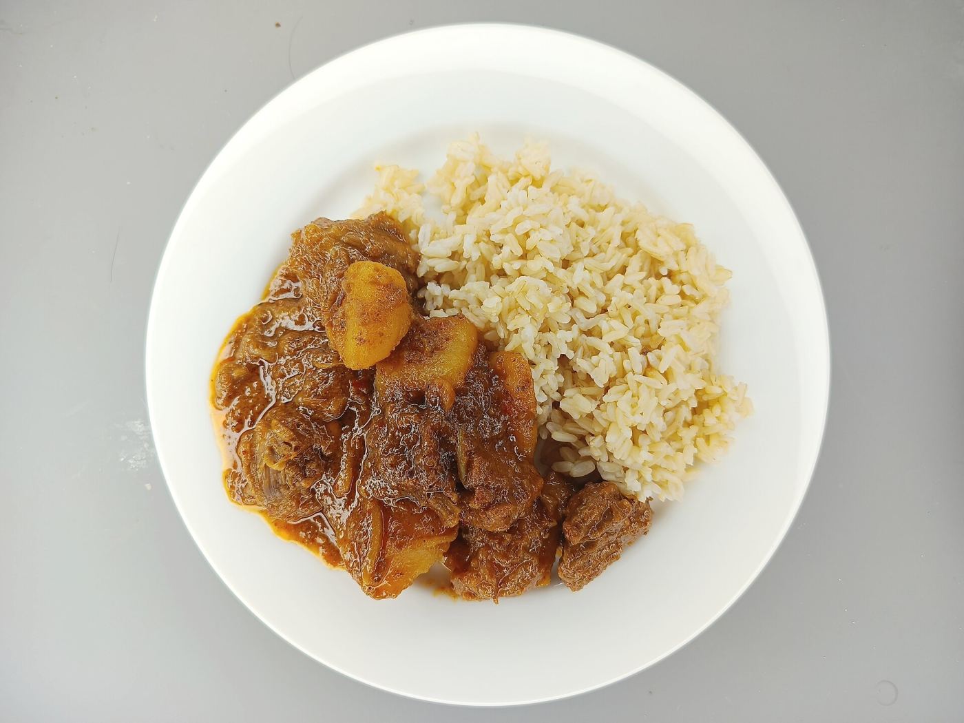 A bowl of massaman curry with rice