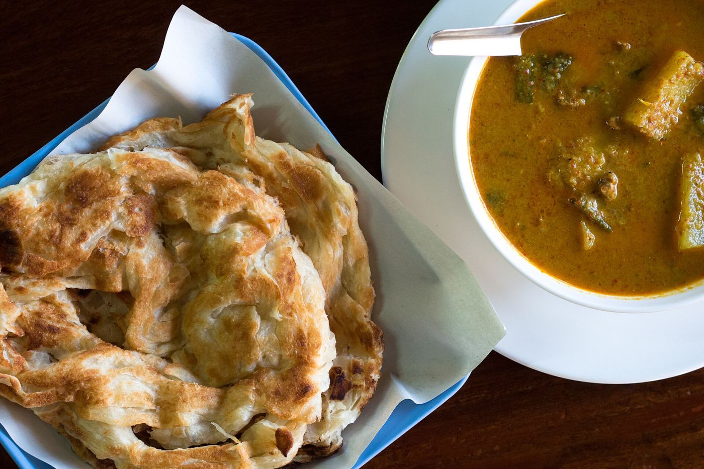 Roti served with curry, a savory variation of the sweet street snack