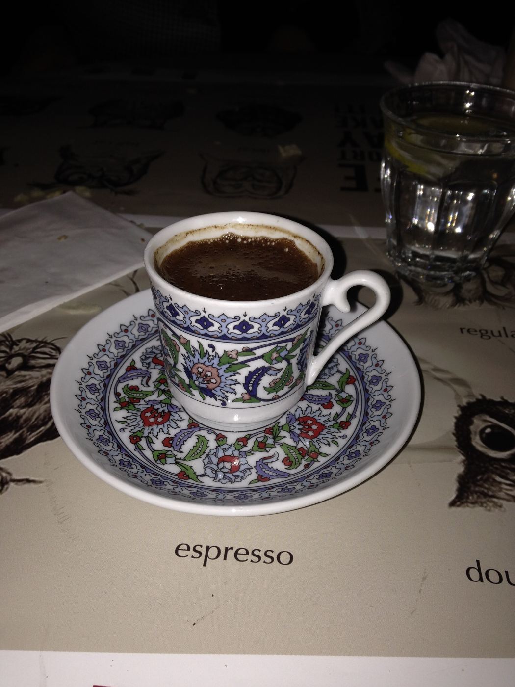 A cup of Turkish coffee served on a saucer