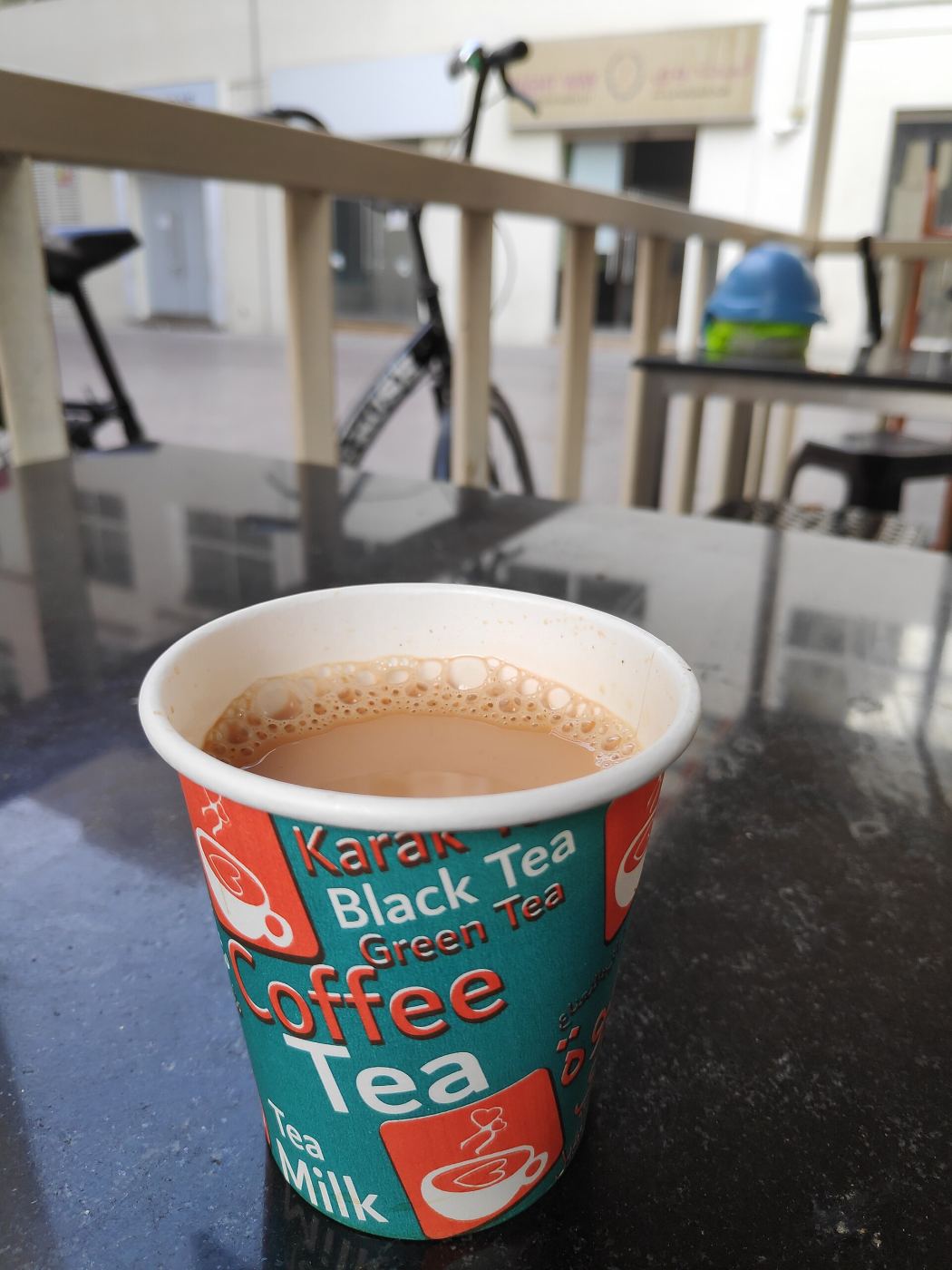 A cup of karak tea being poured