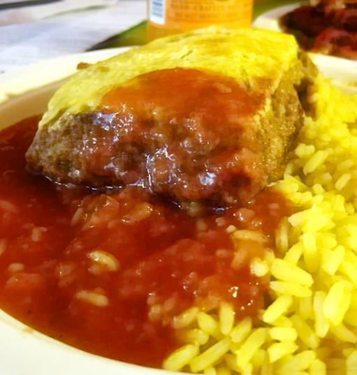 A dish of bobotie with its characteristic baked egg topping