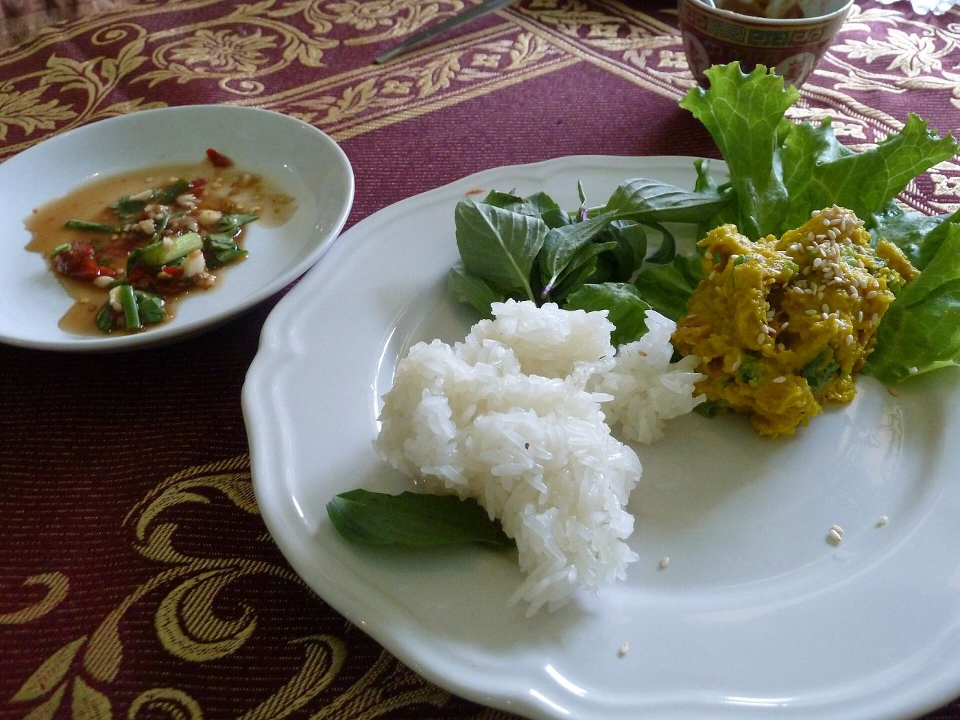 A traditional Thai dish served with rice and dipping sauce at a Bangkok cooking school