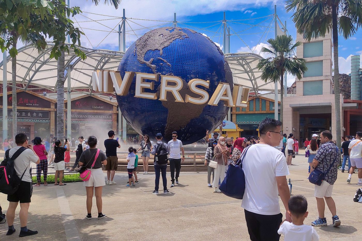 Visitors gathered around the rotating Universal Studios globe at Resorts World Sentosa, Singapore