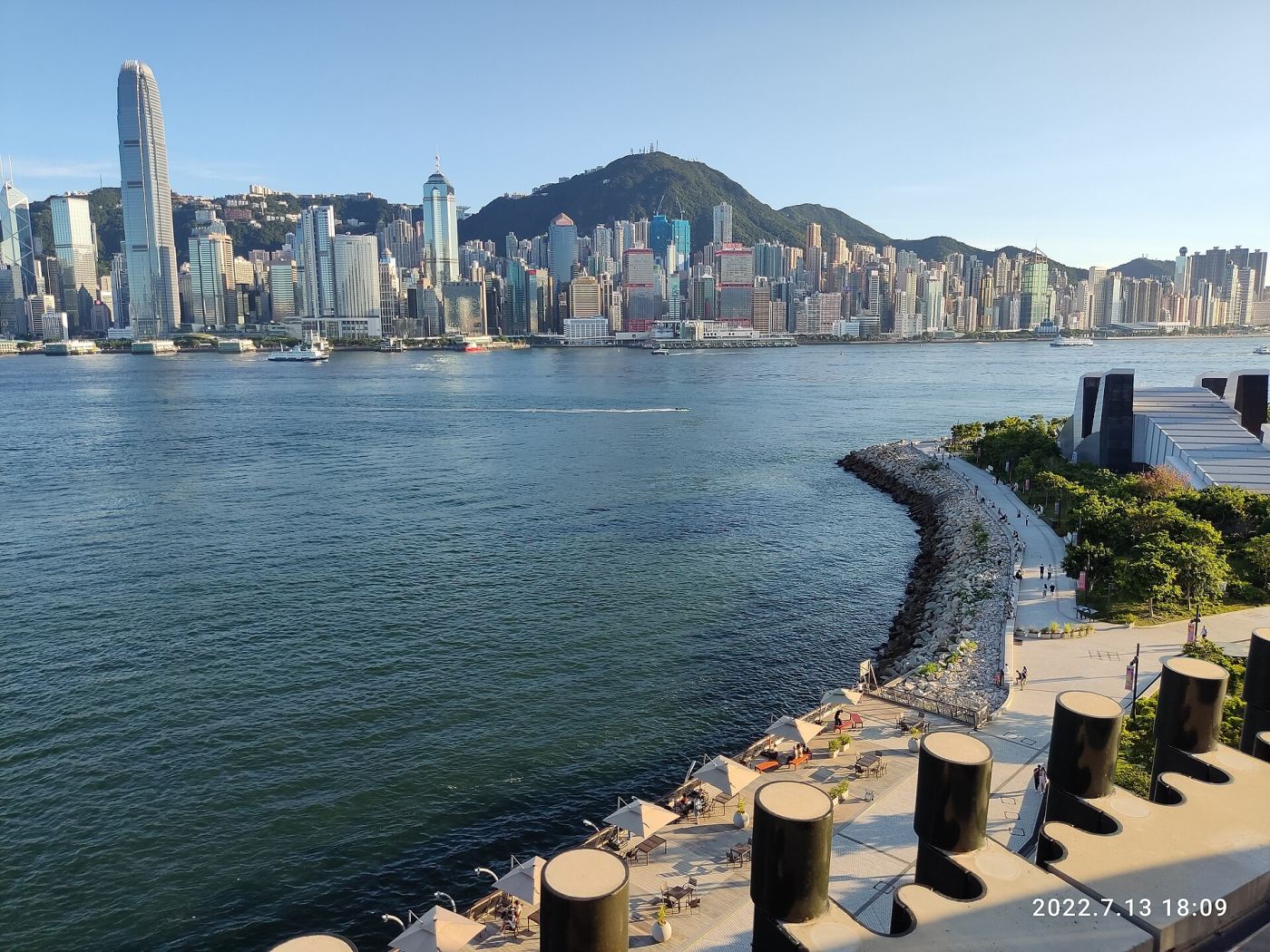 View of Victoria Harbour and the Hong Kong Island skyline from the M+ Museum waterfront promenade