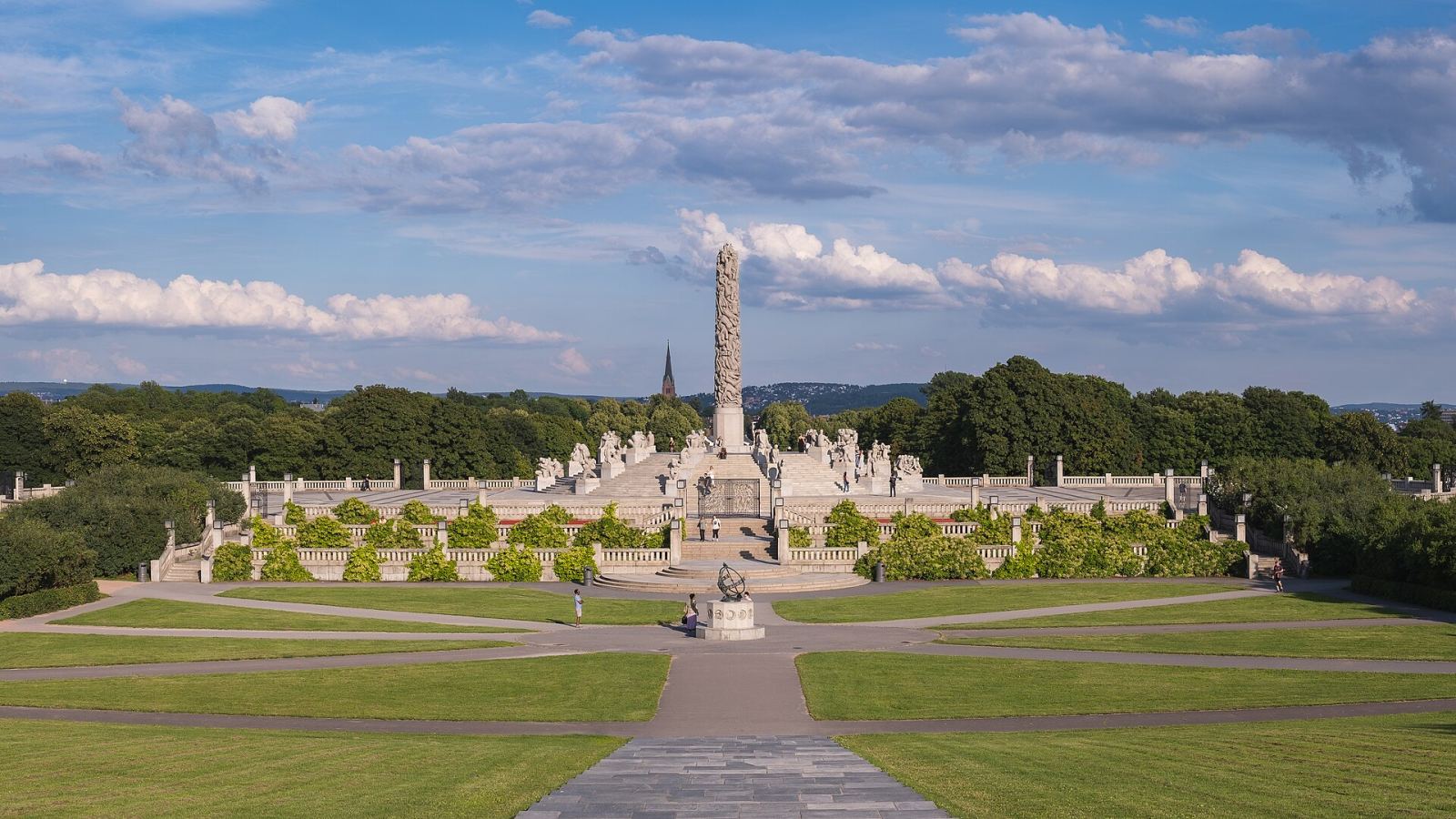 A wide panoramic view of Vigeland Sculpture Park in Oslo with its central monolith and sculptures
