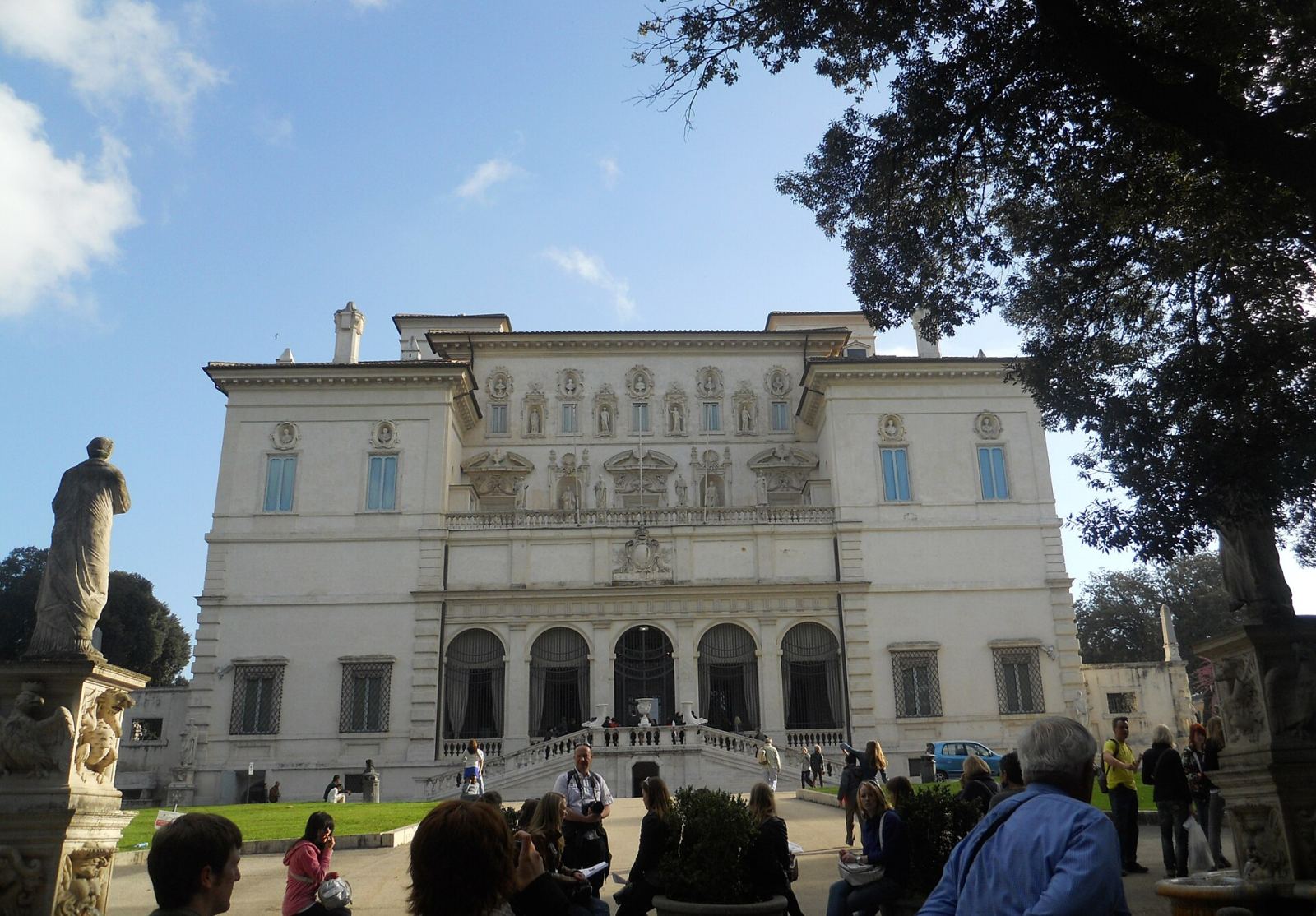 The elegant facade of the Borghese Gallery villa in Rome, surrounded by gardens
