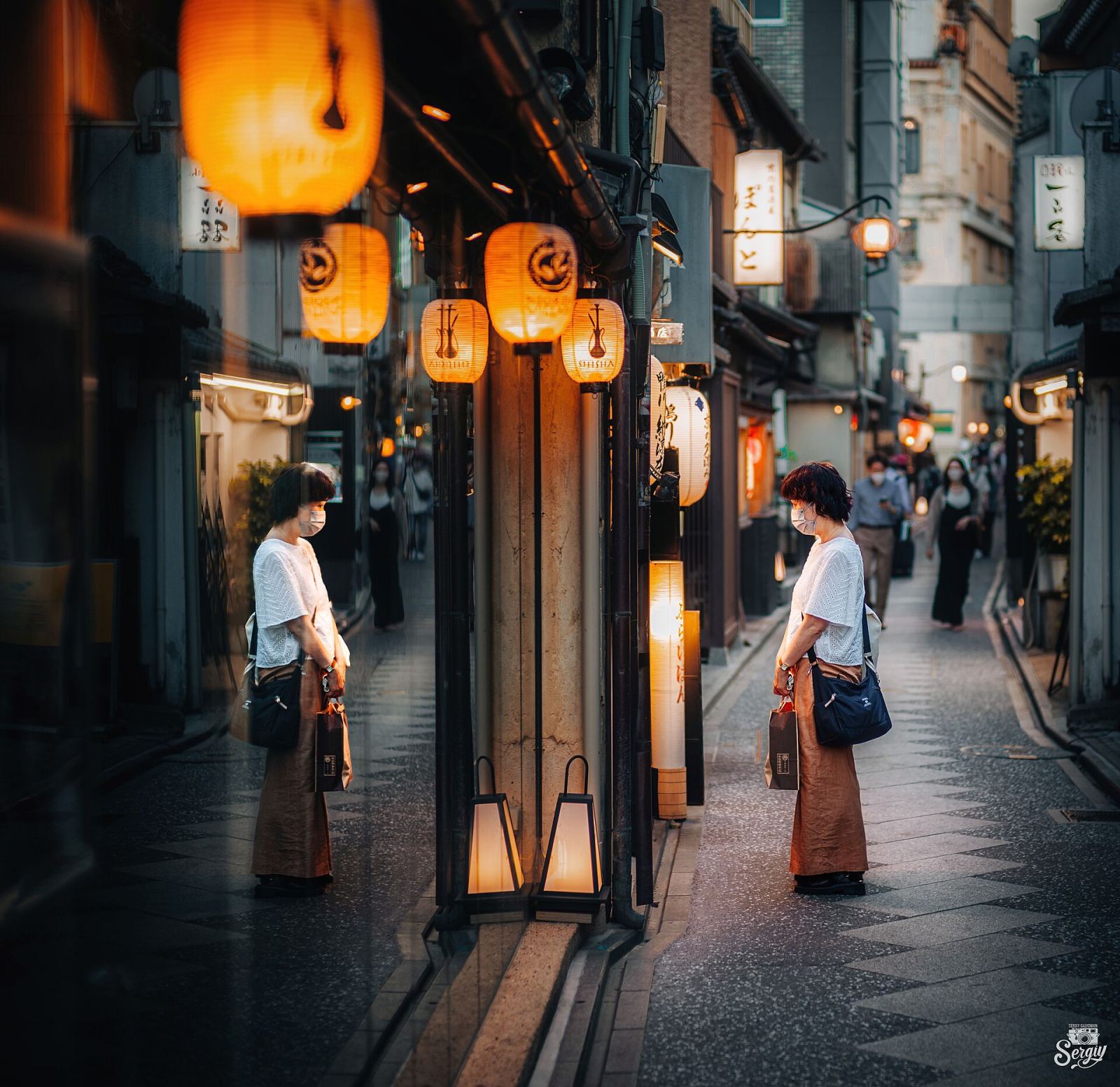 Lanterns and shopfronts reflected along Pontocho Alley in Kyoto