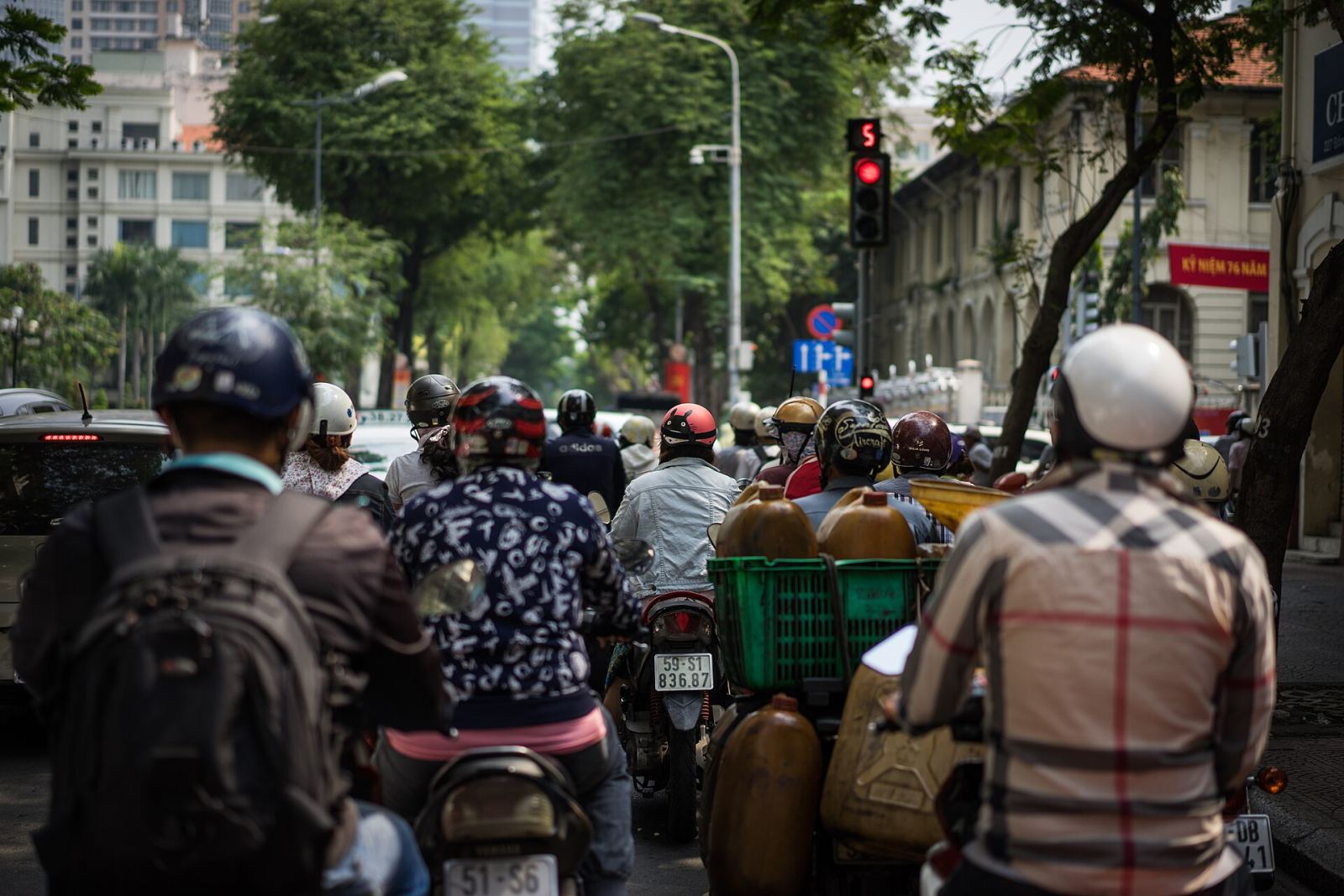 Motorbike traffic on Dong Khoi Street in Ho Chi Minh City with colonial buildings