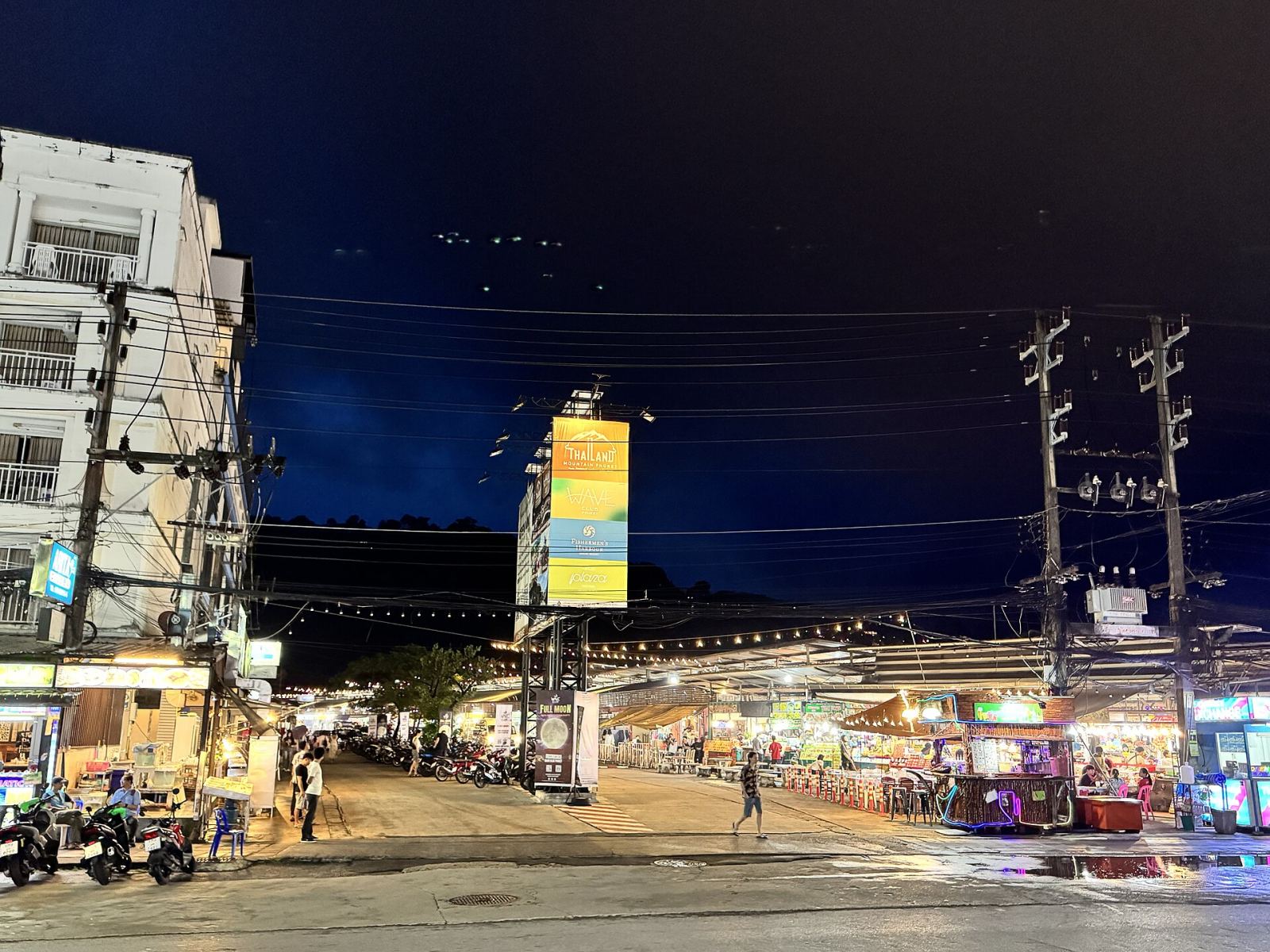 Entrance to a Phuket night market with illuminated signage and stalls