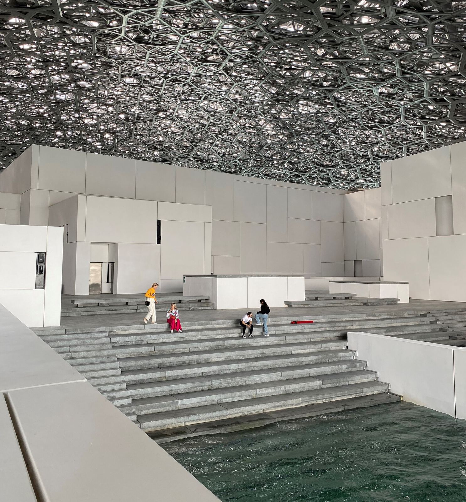 Louvre Abu Dhabi's perforated dome ceiling casting light patterns