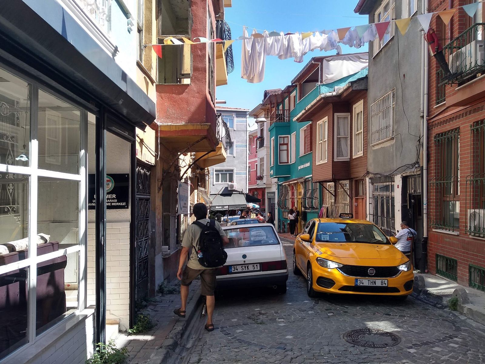 Narrow street in Balat, Istanbul, with colorful houses and hanging laundry