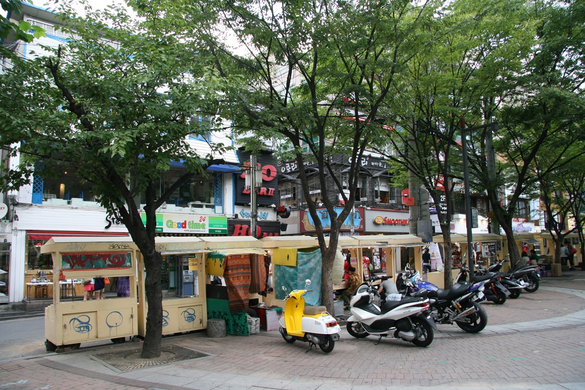 Hongdae Playground area in Seoul with shops and parked scooters